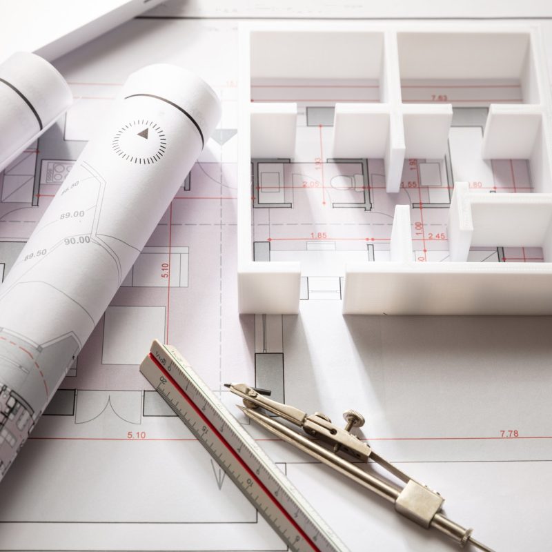 Construction concept. Residential building drawings and house model,